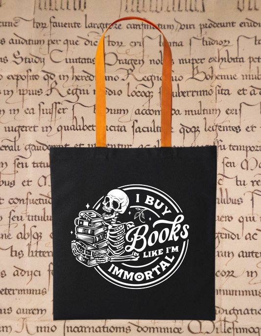 I Buy Books Like I’m Immortal Tote Bag – Gothic Skull Book Bag – Bookish Gift for Readers – Eco Cotton Tote for Book Addicts – Black & Orange Handles